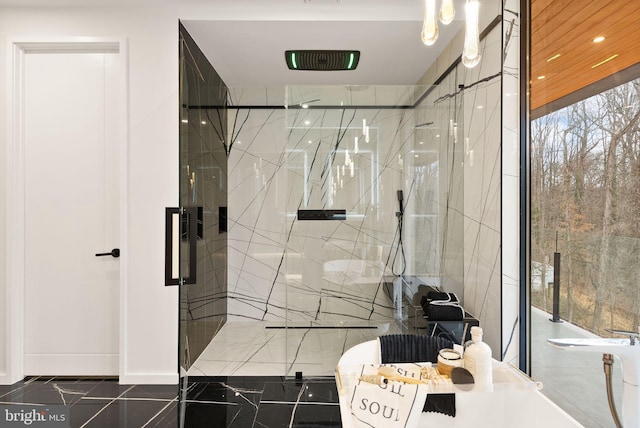 bathroom with marble finish floor, a marble finish shower, and recessed lighting