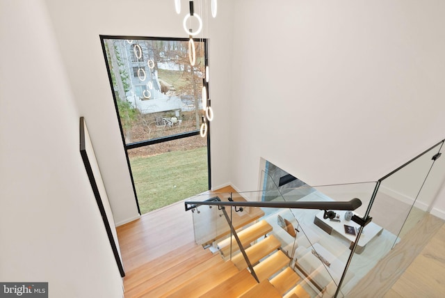 staircase with baseboards and wood finished floors