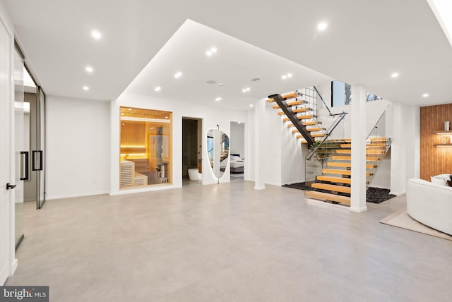 living room with stairway and recessed lighting