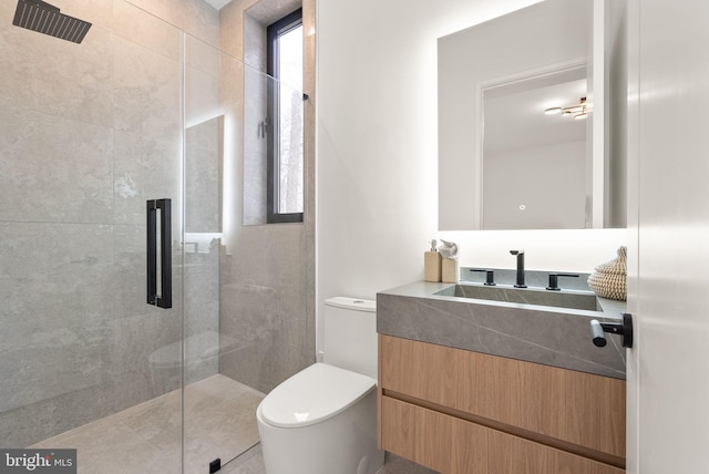 bathroom featuring a shower stall, toilet, and vanity