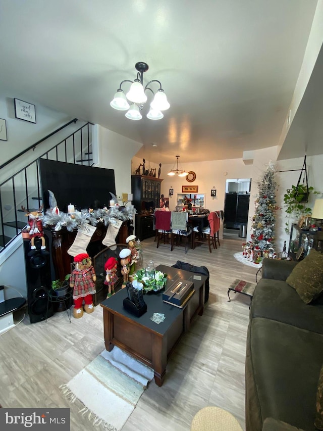 living area with stairs and a chandelier