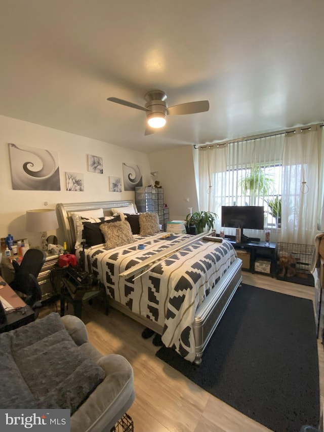 bedroom featuring wood finished floors and a ceiling fan