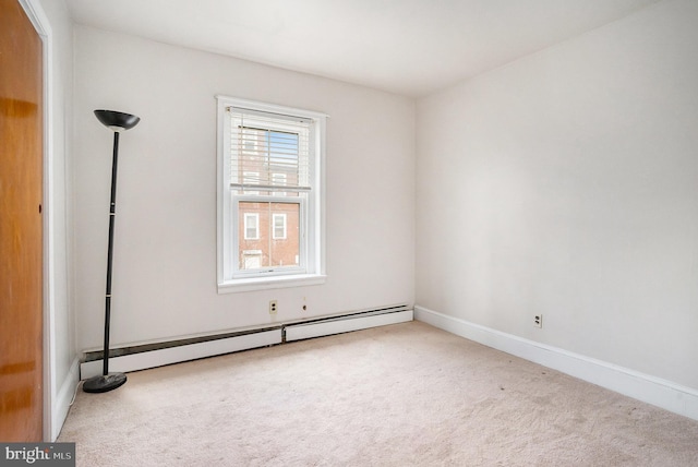 spare room featuring baseboards, carpet floors, and baseboard heating