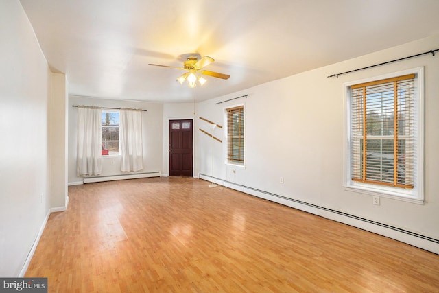 unfurnished room with a ceiling fan, light wood-style floors, baseboards, and a baseboard radiator