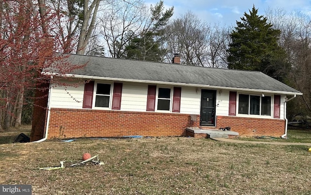 ranch-style home with a front lawn, brick siding, roof with shingles, and a chimney