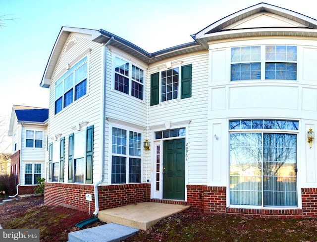 view of front of home with a garage and brick siding