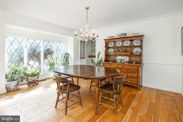 dining space featuring crown molding and light wood-style flooring