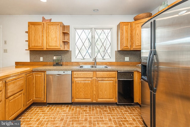 kitchen with open shelves, a sink, decorative backsplash, light countertops, and stainless steel appliances