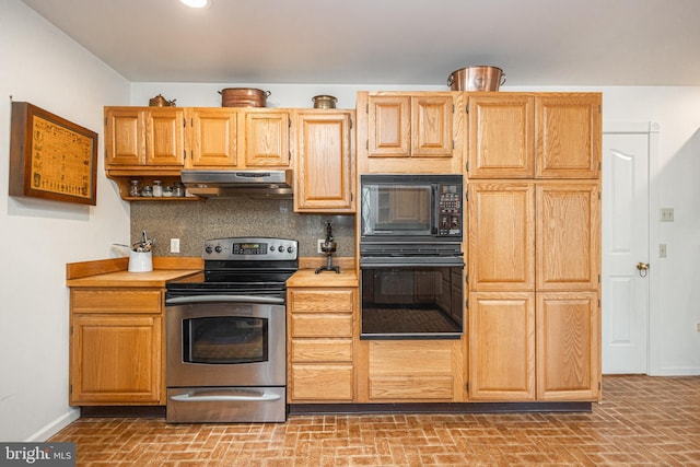 kitchen with baseboards, under cabinet range hood, light countertops, decorative backsplash, and black appliances