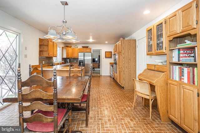 dining space with recessed lighting and brick floor