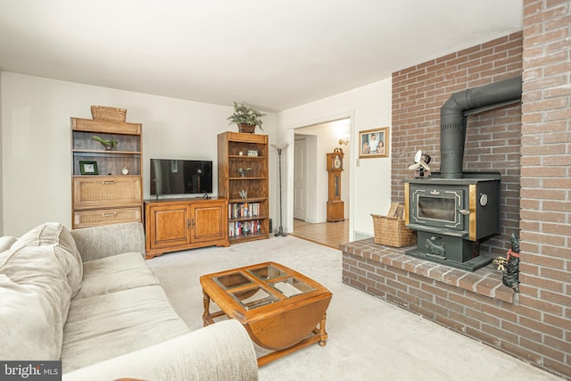 living room featuring light colored carpet and a wood stove