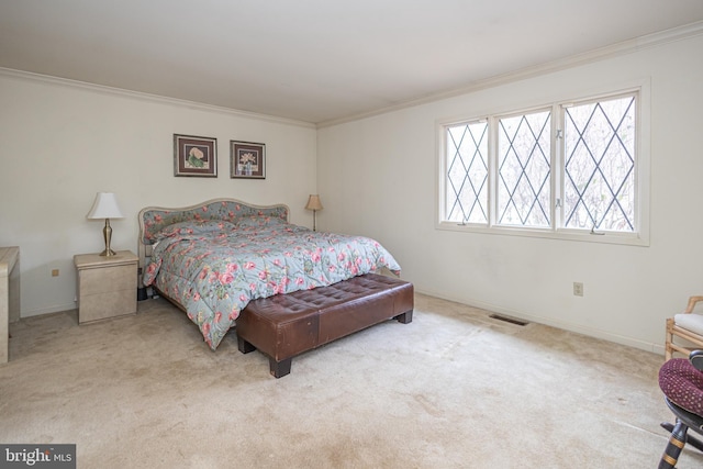 carpeted bedroom featuring visible vents, baseboards, and ornamental molding