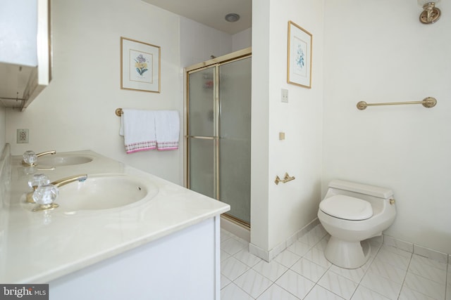 bathroom with toilet, a stall shower, a sink, double vanity, and baseboards