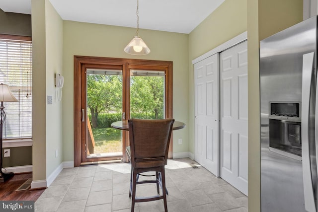 interior space featuring a healthy amount of sunlight and baseboards