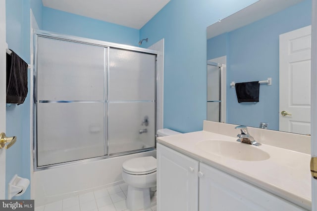 bathroom with vanity, shower / bath combination with glass door, tile patterned flooring, and toilet