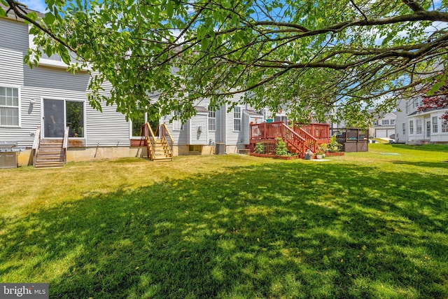 view of yard with entry steps and a wooden deck