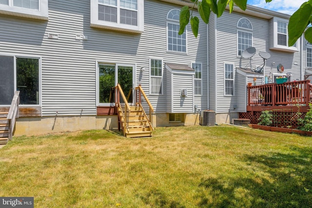 rear view of house with a yard and central AC unit