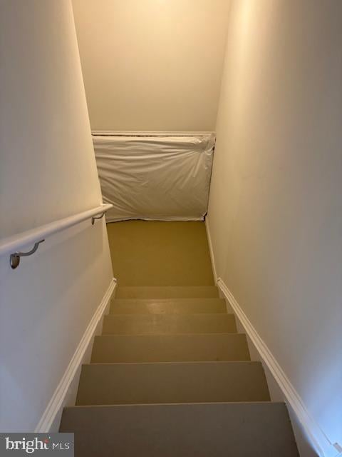 staircase featuring baseboards