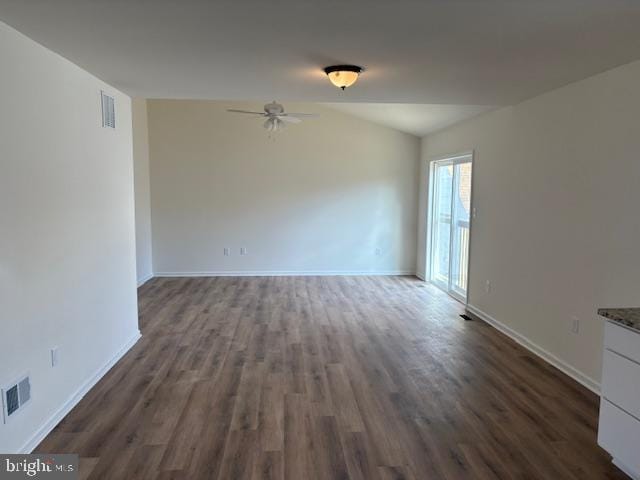 unfurnished room featuring dark wood-type flooring, visible vents, lofted ceiling, and ceiling fan