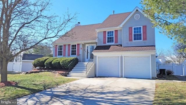 view of front of home featuring a shingled roof, concrete driveway, a chimney, an attached garage, and fence