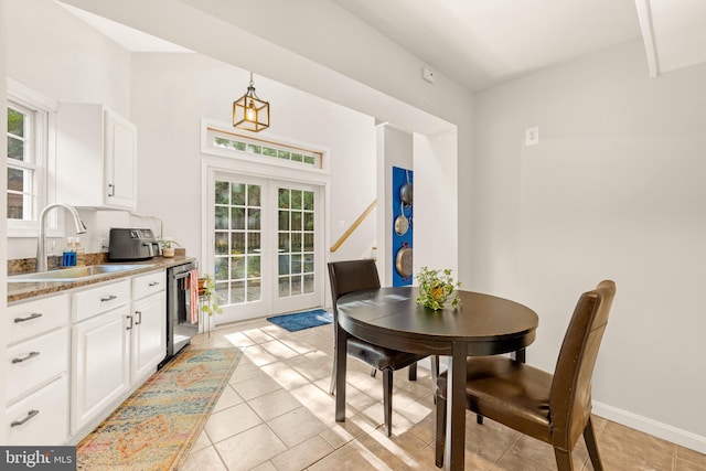 dining room featuring light tile patterned floors, baseboards, and french doors