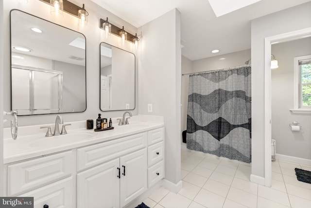 bathroom with double vanity, visible vents, tile patterned flooring, a sink, and a shower with curtain