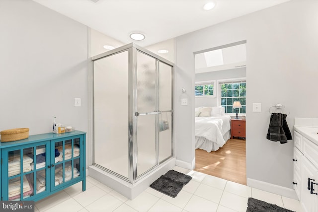 full bathroom with a stall shower, vanity, ensuite bathroom, and tile patterned floors