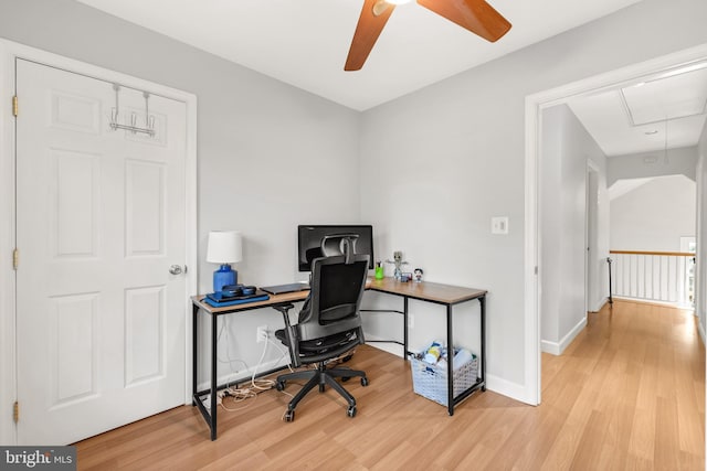 office area featuring attic access, baseboards, and wood finished floors