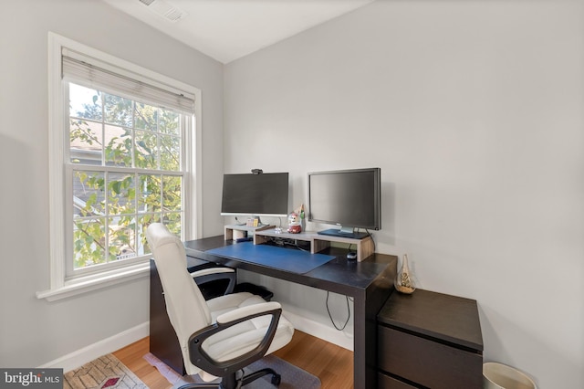 office with visible vents, baseboards, and wood finished floors