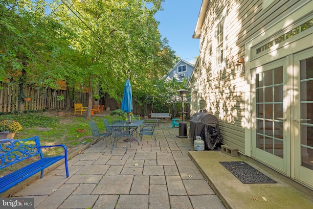 view of patio / terrace featuring outdoor dining area, fence, and grilling area