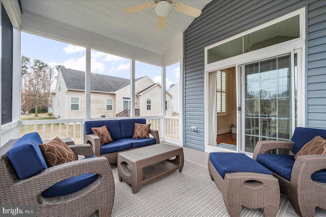 sunroom / solarium featuring ceiling fan and vaulted ceiling