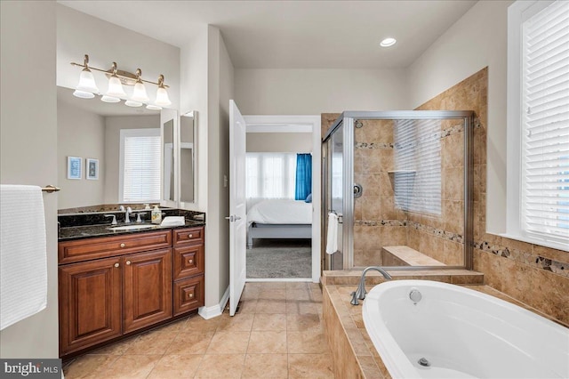 bathroom featuring a stall shower, connected bathroom, vanity, tile patterned flooring, and a bath