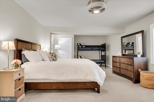 bedroom featuring light carpet and baseboards