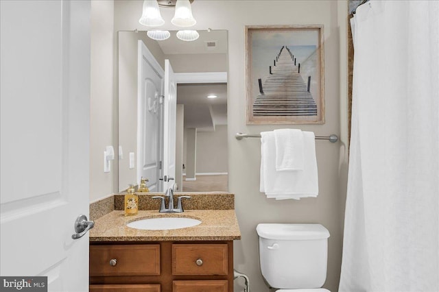 full bathroom featuring toilet and vanity