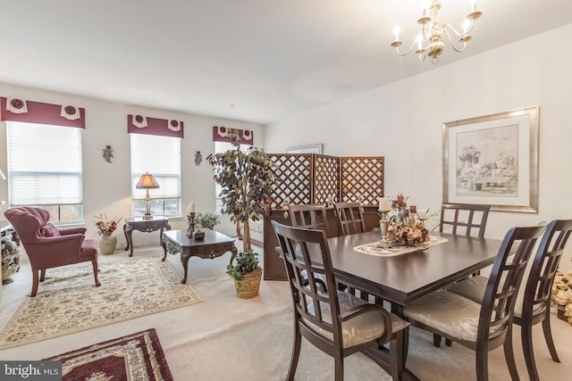 carpeted dining space featuring a notable chandelier