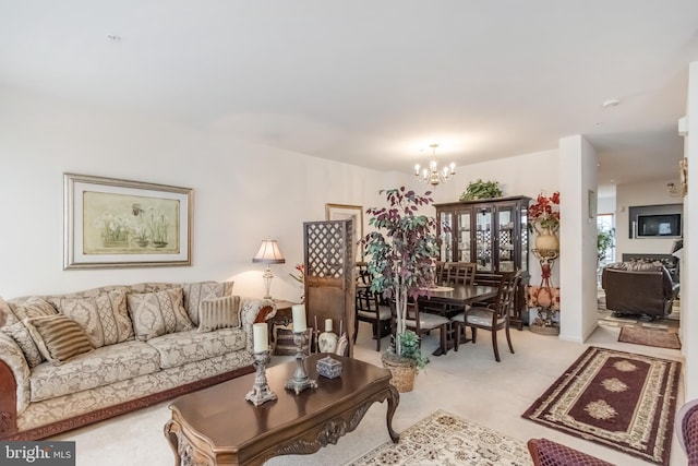 living area with light colored carpet and a notable chandelier