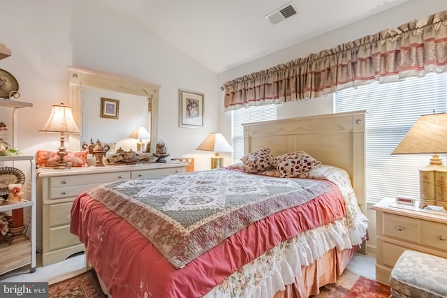 bedroom with lofted ceiling and visible vents