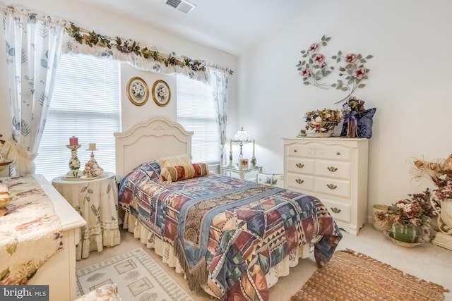 bedroom with light carpet and visible vents