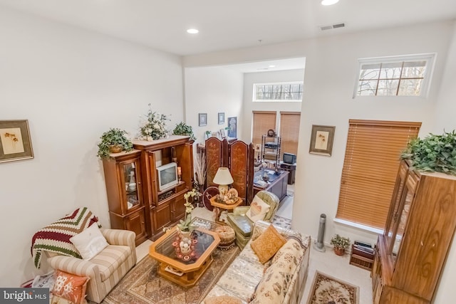 living area featuring carpet, visible vents, and recessed lighting