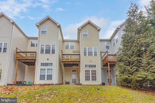 rear view of property featuring a yard and central AC unit