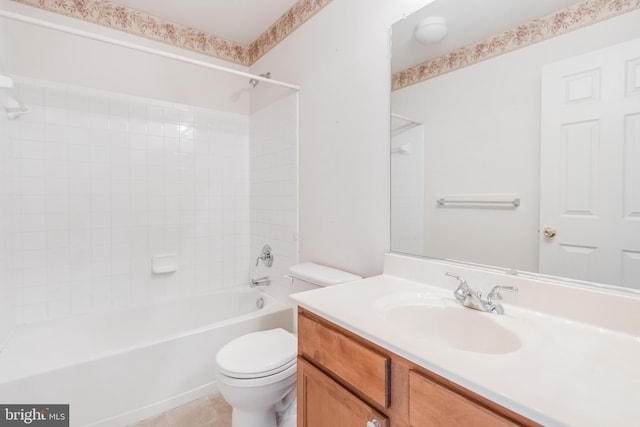 bathroom featuring toilet, washtub / shower combination, vanity, and tile patterned flooring