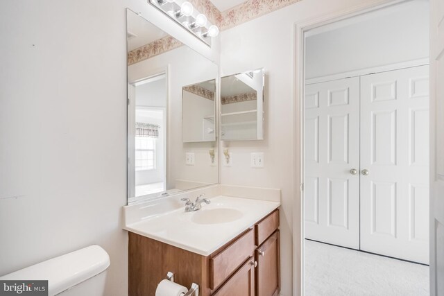 half bathroom featuring toilet and vanity