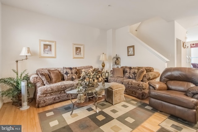 living area featuring stairs and wood finished floors