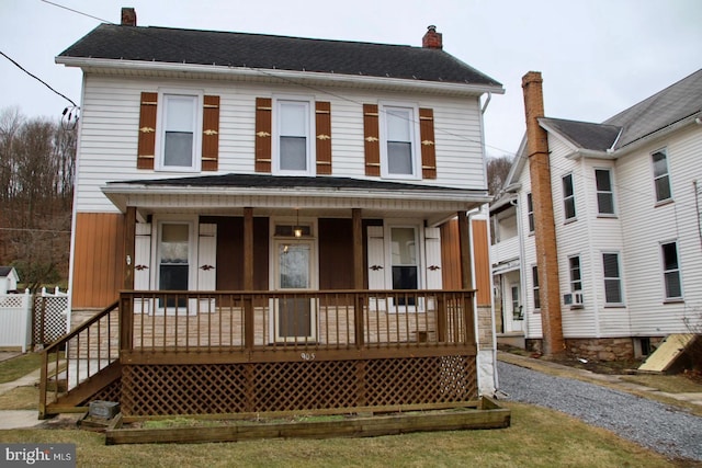 view of front of property with covered porch and a chimney