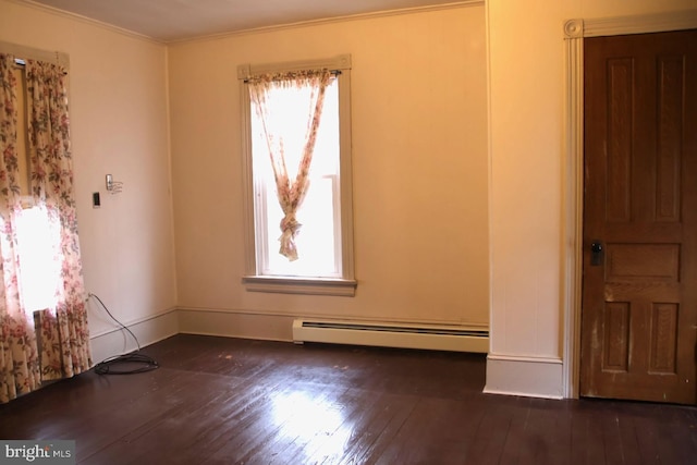 unfurnished room featuring a baseboard heating unit, hardwood / wood-style floors, and ornamental molding