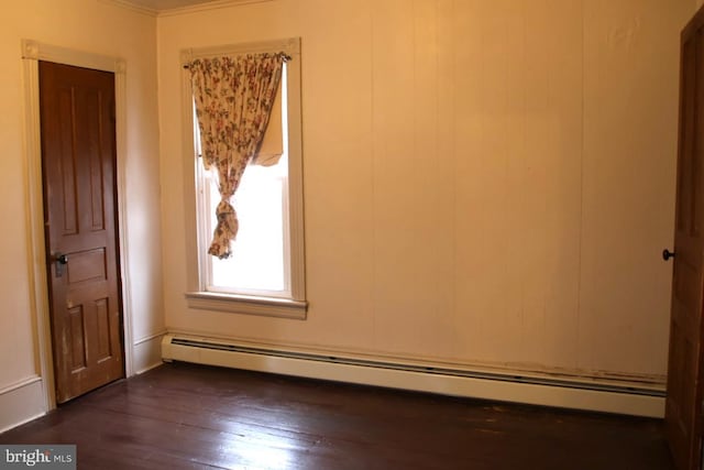 unfurnished room featuring dark wood-style floors and a baseboard radiator