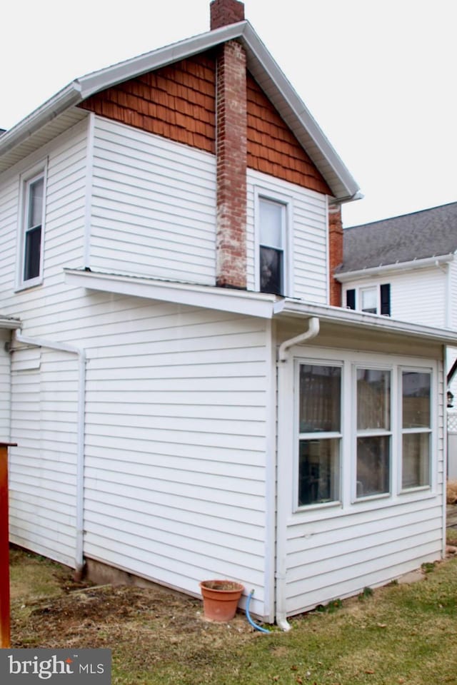 view of side of property with a chimney