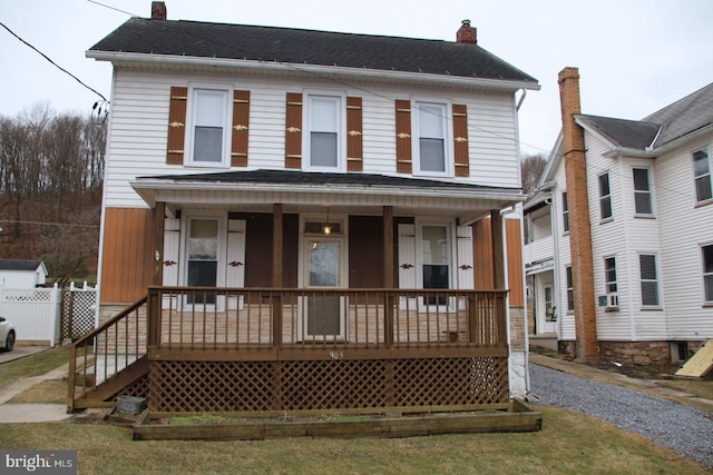 view of front of house featuring a porch and a chimney