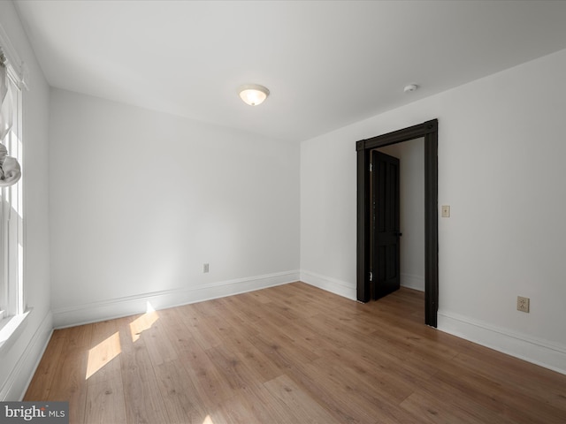 unfurnished room with wood finished floors and baseboards