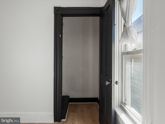 interior details featuring wood finished floors and baseboards